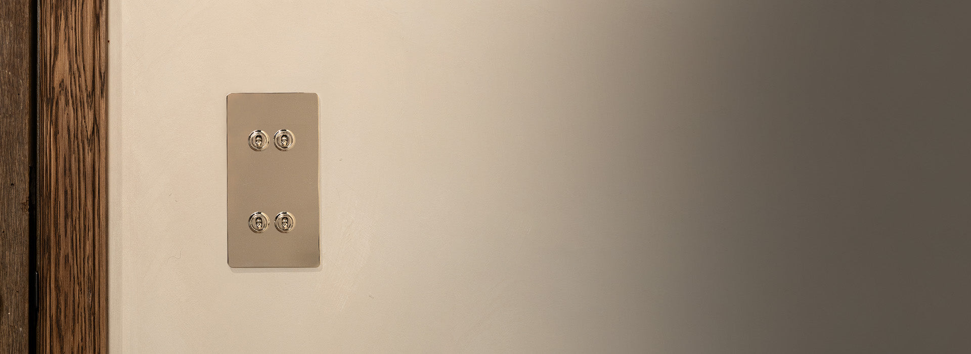 3 toggle switch in polished nickel on grey wall