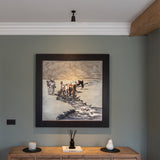 Bronze Baylis Single 50mm Spotlight mounted to white ceiling projecting white light down onto framed artwork mounted to a wall fixed above a wooden copnsole table. 