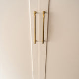 Antique Brass Sycamore Furniture Handle 384mm fitted to cream furniture door, zoomed in. 