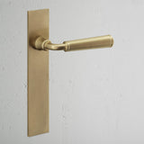 Digby Long Plate Fixed Door Handle Antique Brass Finish on White Background