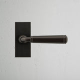 Digby Short Plate Fixed Door Handle Bronze Finish on White Background Front Facing