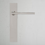 Clayton Long Plate Sprung Door Handle Polished Nickel Finish on White Background Front Facing