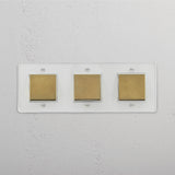 Advanced Light Control System: Triple Rocker Switch in Clear Antique Brass White on White Background