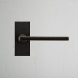 Clayton Short Plate Fixed Door Handle Bronze Finish on White Background Front Facing