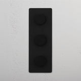 Adjustable Light Control with Vertical Bronze Triple Dimmer Switch on White Background