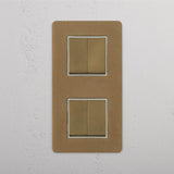 Four Position Vertical Double Rocker Switch in Antique Brass White on White Background