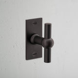 Harper T-Bar Short Plate Fixed Door Handle Bronze Finish on White Background at an Angle