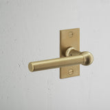 Harper Short Plate Fixed Door Handle Antique Brass Finish on White Background at an Angle